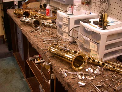 Disassembled Saxophones on the bench